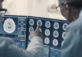People in white coats studying scans of body