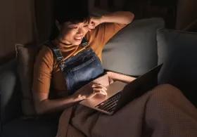 Woman with laptop on sofa 