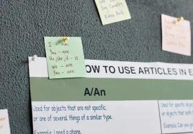 Notes about English grammar displayed on a wall