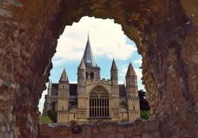 Looking at a large cathedral through a hole in wall
