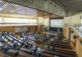 Tutor speaking to a lecture theatre full of students