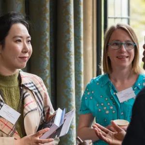 Three women engaging in conversation.