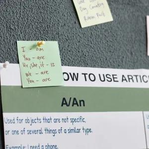 Notes about English grammar displayed on a wall