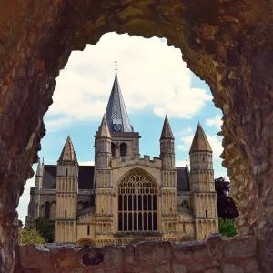 Looking at a large cathedral through a hole in wall