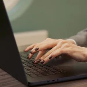 Woman typing on laptop