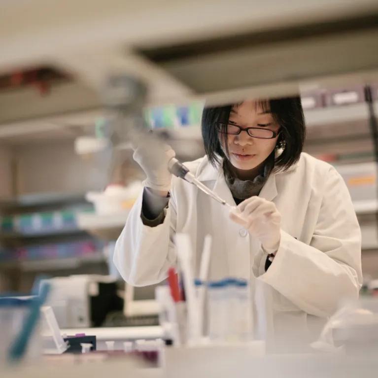 Scientist working in a lab with biological samples