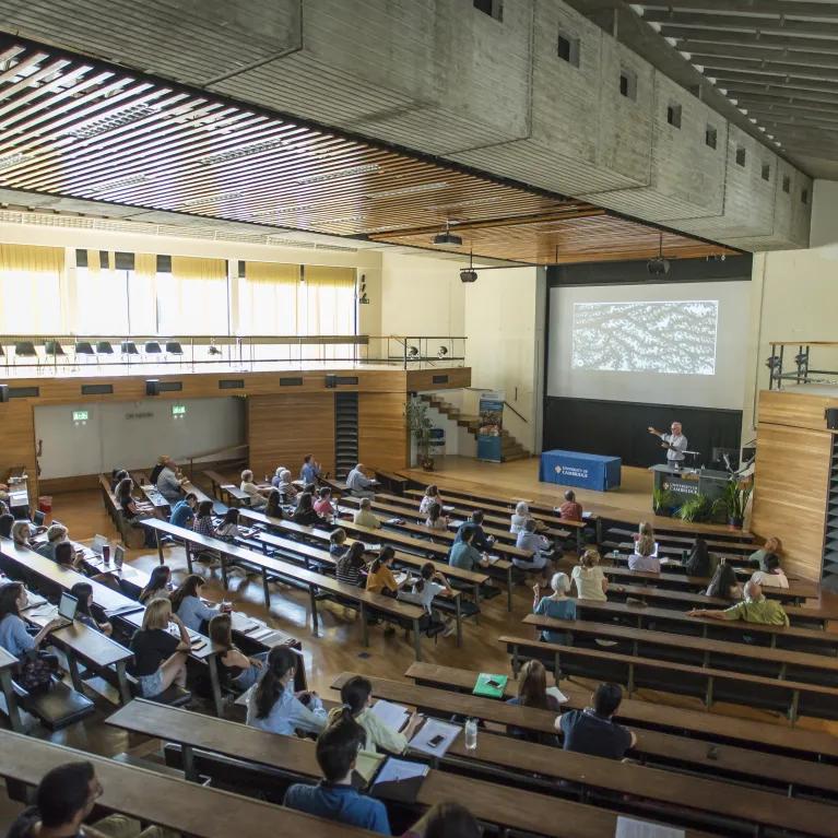 Tutor speaking to a lecture theatre full of students